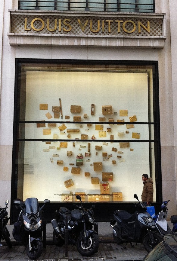 Louis Vuitton put on a correspondence art show off the Champs Elysées in Paris. Above: Stephen Antonokos packages in the storefront vitrine.