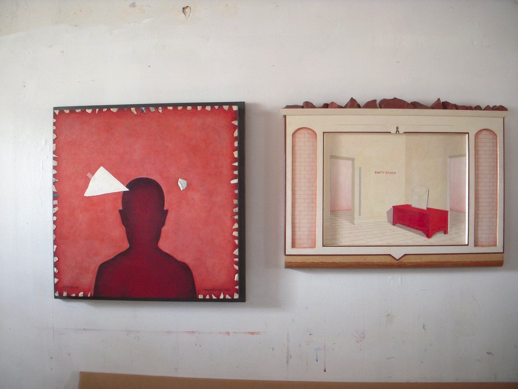 Two paintings by Anne Minich in her studio.