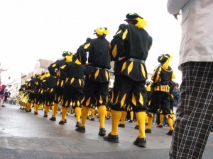 Marching band stepping together.