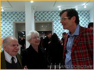 Herb and Dorothy with Richard Tuttle at one of the artist's openings. The diminutive couple are repeatedly towered over, as here, by people who may or may not be that tall but look like giants in comparison.