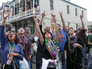 Mardi Gras, Bourbon Street New Orleans, crowd in unison hoping to get some beads. Far from a mystical religious experience...or who knows, maybe for some it is.