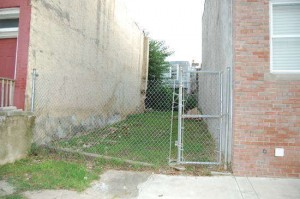 An unexamined and inaccessible vacant lot, seen above, sits across the street from The House That Was Here.