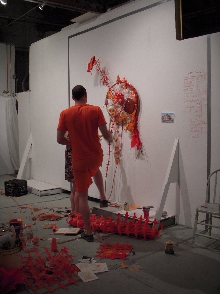 Scott Bickmore working at Little Berlin on his all orange community art