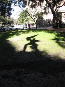 Shadow of sculpture of Revolutionary War soldier Sgt. William Jasper in one of Savannah's squares.