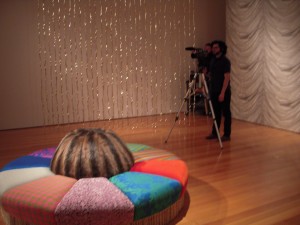 Virgil Marti's installation with fur-covered lounge-seat and shimmery golden bones curtain.