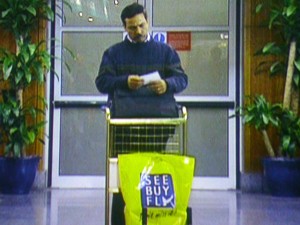 The last man standing in front of the arrivals door, looking at his paper. Will it help him know where to go and what to do?